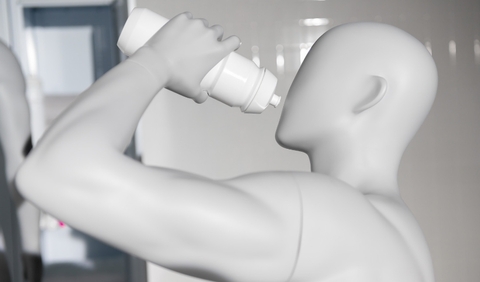 A man is drinking a bottle of water