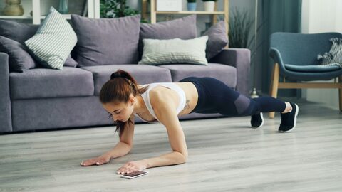a woman is doing a body plank in her living room 