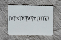 The word breathe is stamped on to a white paper 