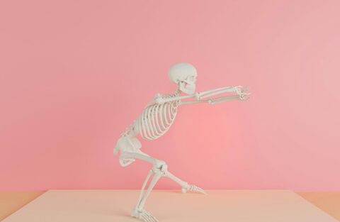 A skeleton is doing a lunge and forward reach 