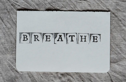 The word breathe is stamped on to a white paper 